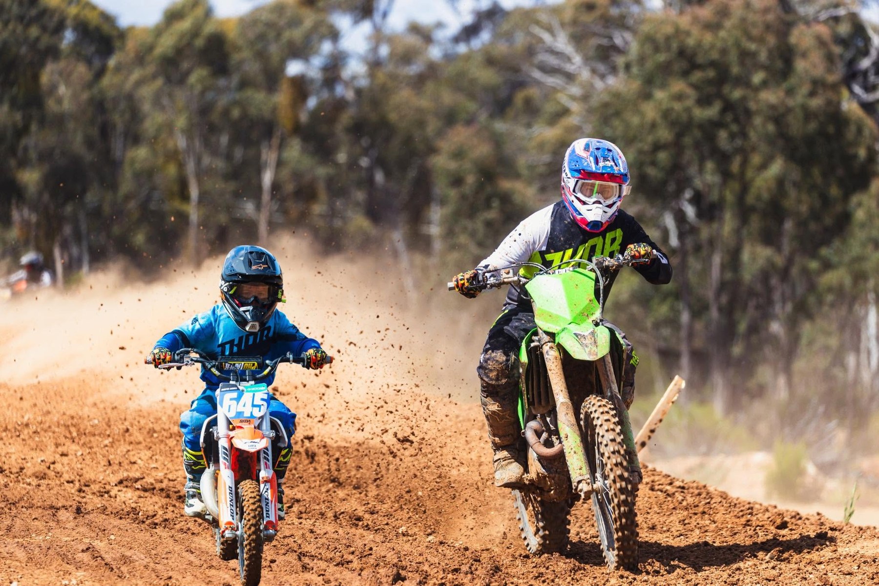 Local motocross riders competing on a dirt track