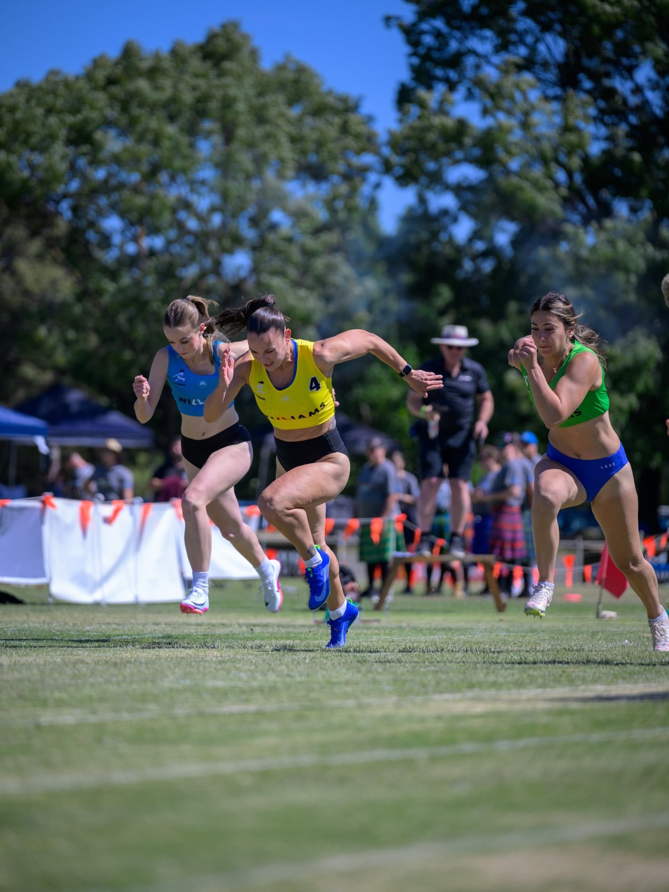 Track and field athletes sprinting in competition